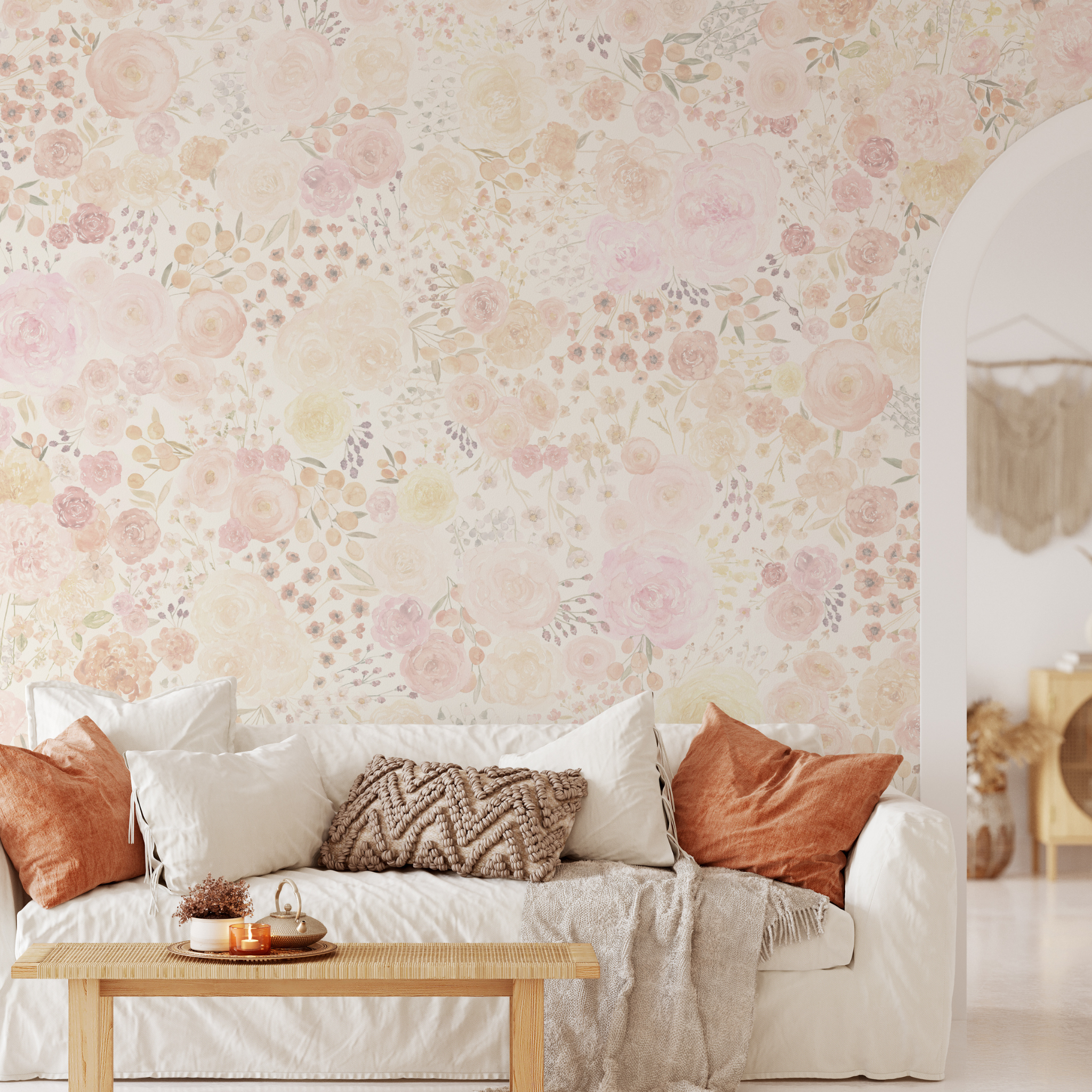 Alt: "Lucy Wallpaper by Wall Blush featuring floral patterns in a cozy living room with a plush white sofa and wooden table."
