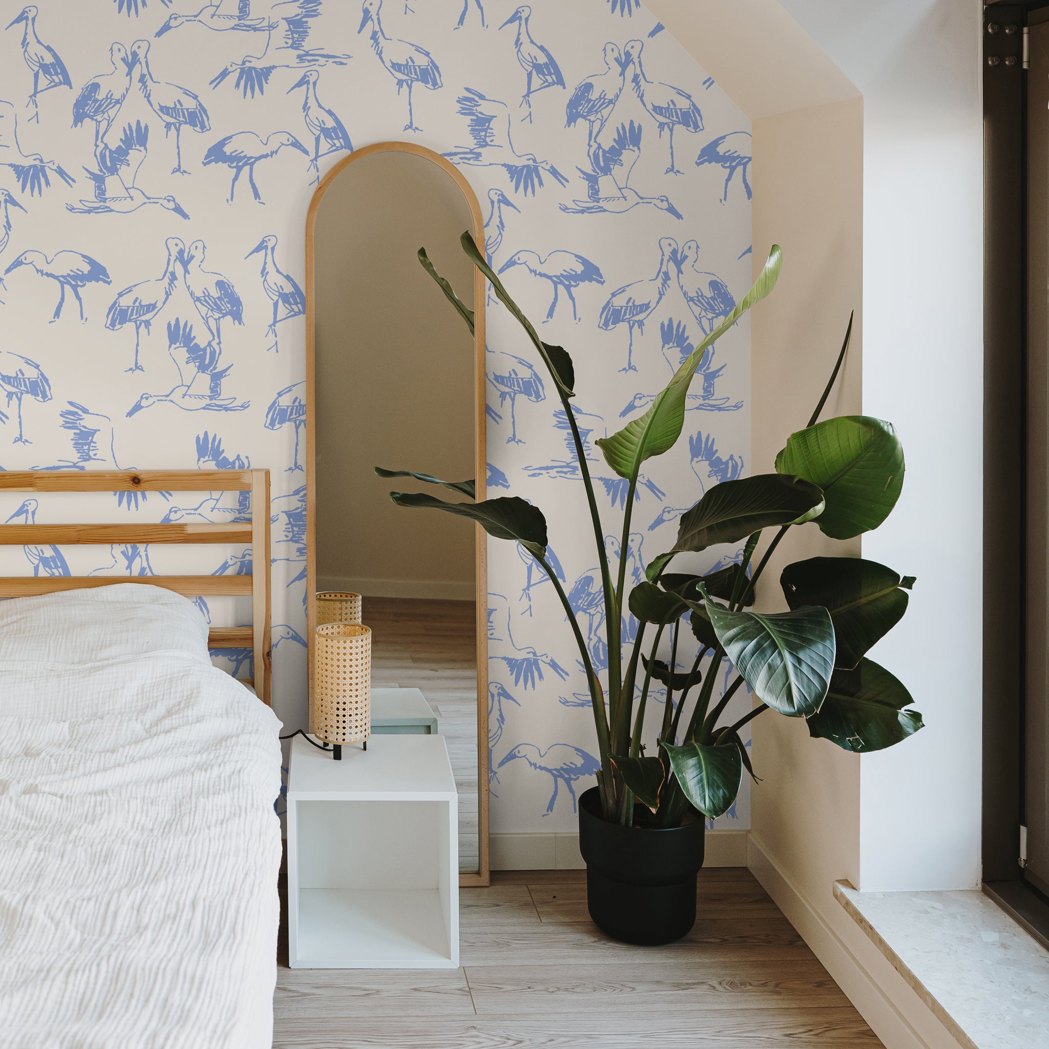 "Wall Blush's Matteo and Malena Wallpaper in a stylish bedroom setting, showcasing vibrant bird patterns."