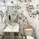 "Wall Blush's Midnight Flower Wallpaper in a stylish bathroom, showcasing elegant floral designs with a modern touch."
