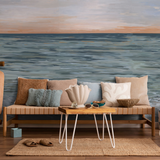 "Coastal-themed living room featuring New Beginnings Wallpaper by Wall Blush, with ocean scene focus."