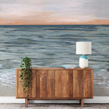 "Wall Blush's New Beginnings Wallpaper adding serene ocean vibes to a stylish living room interior."