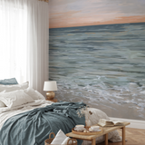 "Wall Blush's New Beginnings Wallpaper in a serene bedroom, showcasing the calming coastal design."