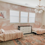 "The Nora Mural Wallpaper by Wall Blush in a cozy bedroom setting, with soft lighting and elegant decor."
