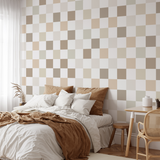 "Ollie Wallpaper by Wall Blush in a cozy bedroom with modern checkered design, enhancing the room's warm ambiance."