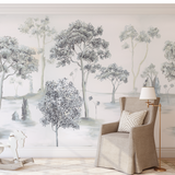 "Otilia Wallpaper by Wall Blush featuring tranquil forest scene in a cozy living room, accentuating the wall."