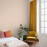 Wall Blush's Peachy Plaid Wallpaper featured in a cozy bedroom setting, with a focus on the wall design.
