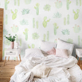 "Wall Blush 'Petals and Prickles (Large) Wallpaper' in a cozy bedroom, featuring vibrant cactus designs."