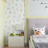 "Cozy bedroom featuring Wall Blush Petals and Prickles (Small) Wallpaper with cactus design."