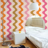 "Wall Blush Polly Wallpaper showcasing colorful waves in a modern bedroom, highlighting vibrant wall focus."
