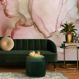 "Wall Blush Rose Quartz Wallpaper in stylish living room with green velvet sofa and gold accents."