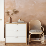 "Sedona Wallpaper by Wall Blush showcases in modern bedroom, highlighting textured peachy wall as focal point."