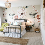 "Wall Blush's Terracotta Blooms Wallpaper showcased in cozy bedroom setting, highlighting elegant floral design focus."