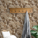 Wall Blush AW01's The Abbey Wallpaper featured in a cozy room with a wicker chair and stone pattern focus.
