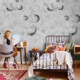To the Moon Wallpaper by The Minty Line in a cozy, modern children's bedroom, highlighting the whimsical space theme.
