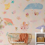 "Wall Blush's Under The Sea Wallpaper in a nursery room, featuring ocean life illustrations with a focus on the wall decor."