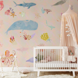"Wall Blush 'Under The Sea Wallpaper' in a cozy nursery room, with whimsical ocean creatures design."