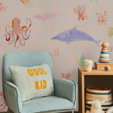 "Wall Blush's 'Under The Sea Wallpaper' in a cozy children's room, highlighting playful ocean fauna design."