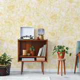 The Dutchess (Mustard) Wallpaper by The Ania Zwara Line in a stylish living room setup.
