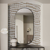 "Zea Wallpaper by Wall Blush in modern bathroom, with elegant brown and white pattern accent wall."