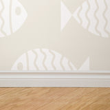 "Wall Blush's Keep Swimming Wallpaper installed on bedroom wall, showcasing subtle fish patterns with focus on design."