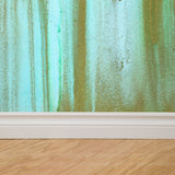 "Wall Blush Venice Wallpaper in a modern living room with abstract green and gold design, focus on wall decor."
