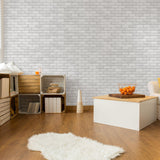 Bella Brick (White) Wallpaper by Wall Blush in cozy living room with rustic decor and wooden accents.
