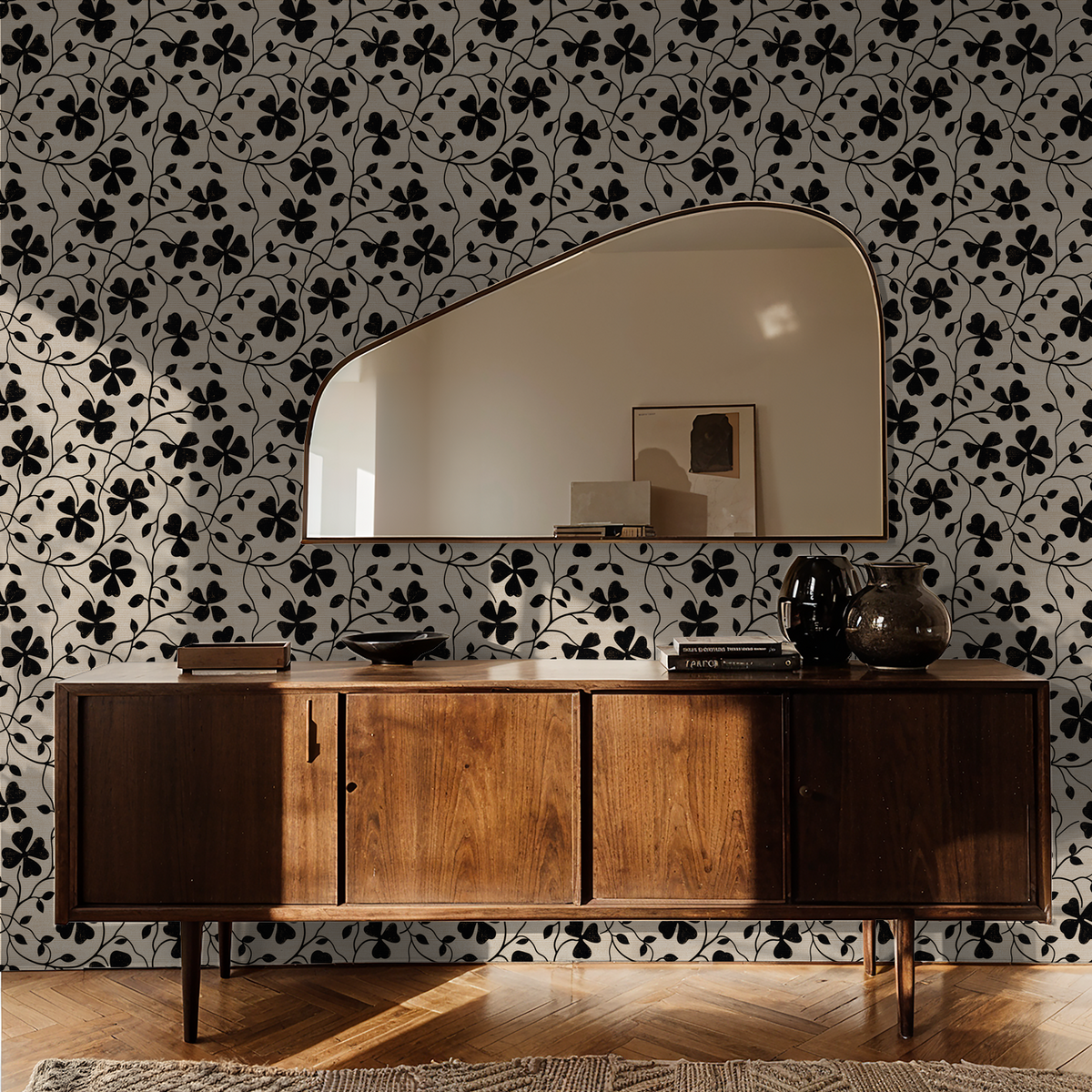 Black floral wallpaper with wooden sideboard and mirror in a modern living room.
