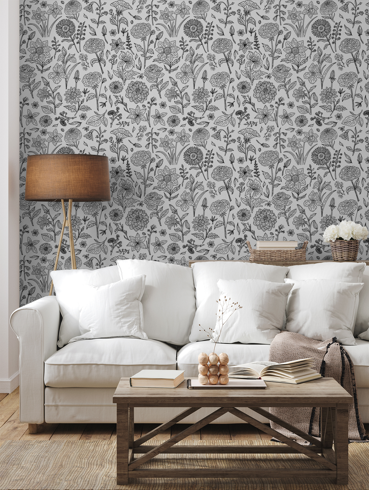 Black and white floral wallpaper in cozy living room with white sofa and wooden table.