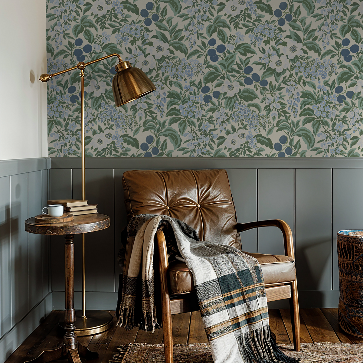 Floral wallpaper in powdery blues and greens in a cozy reading nook with leather chair.