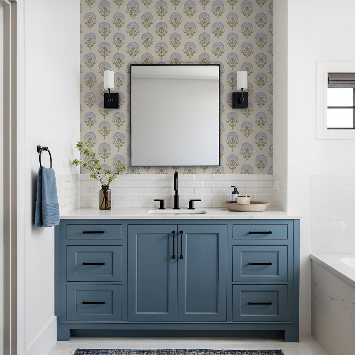 Bathroom with blue floral wallpaper and blue vanity