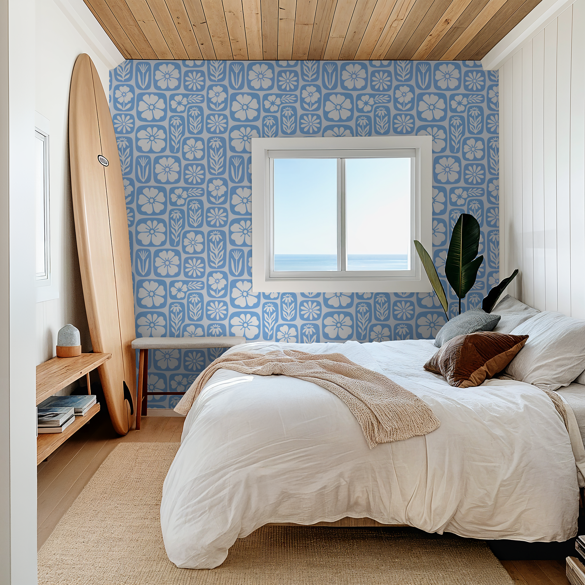 Blue floral wallpaper with white silhouettes in coastal bedroom setting.