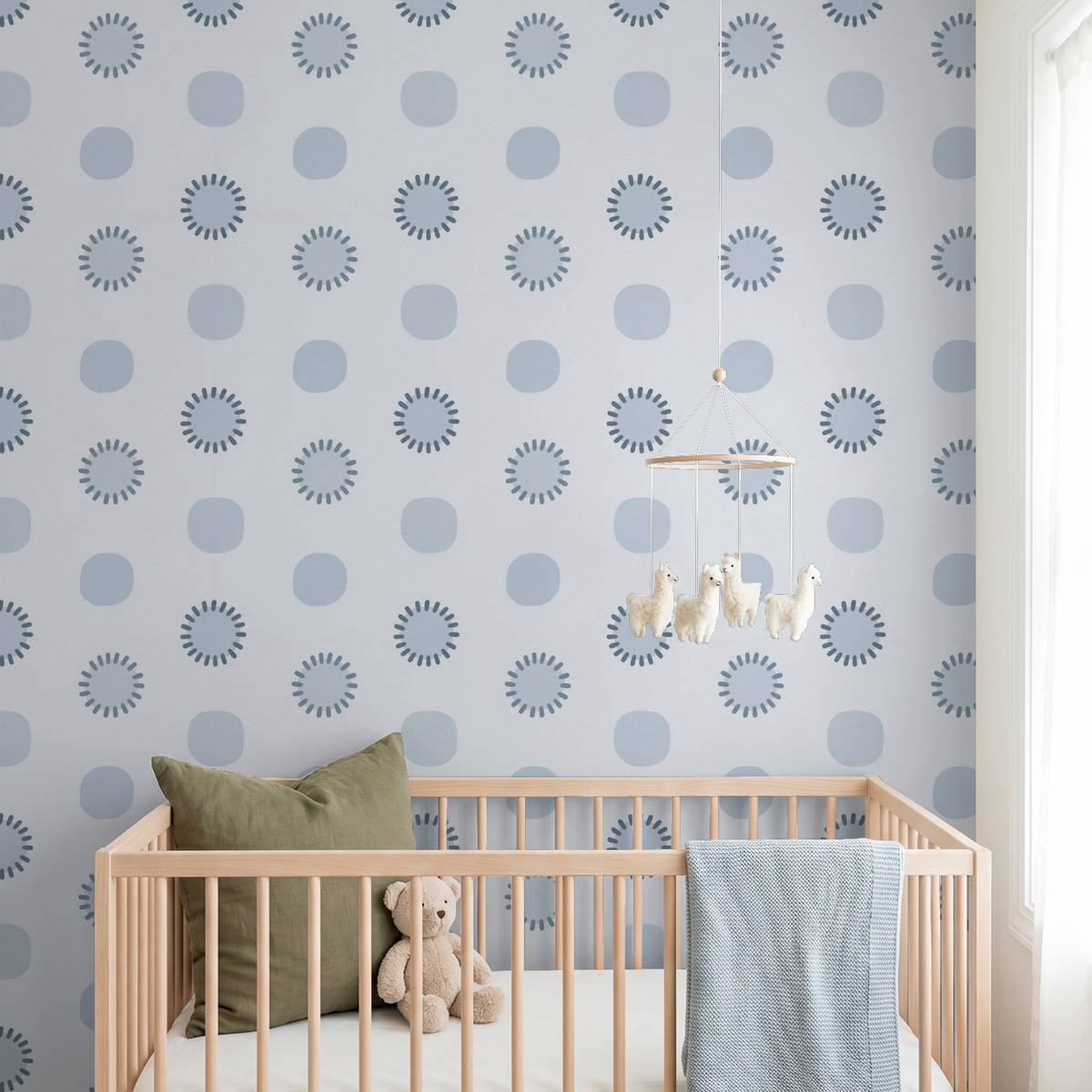 Blue geometric circle wallpaper in a modern nursery with crib and plush toys.