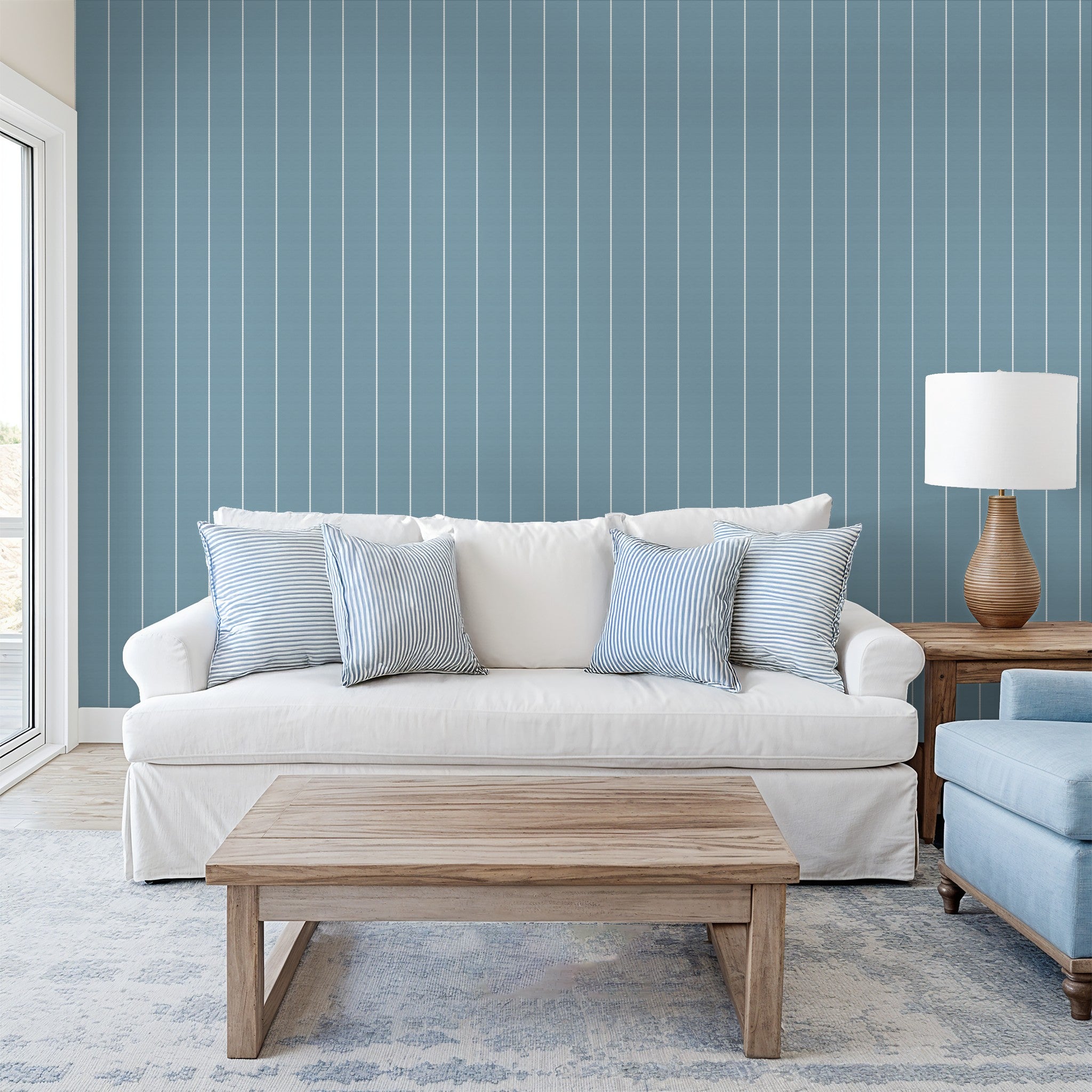 Blue pinstripe dot wallpaper in cozy living room with white sofa and wooden table.
