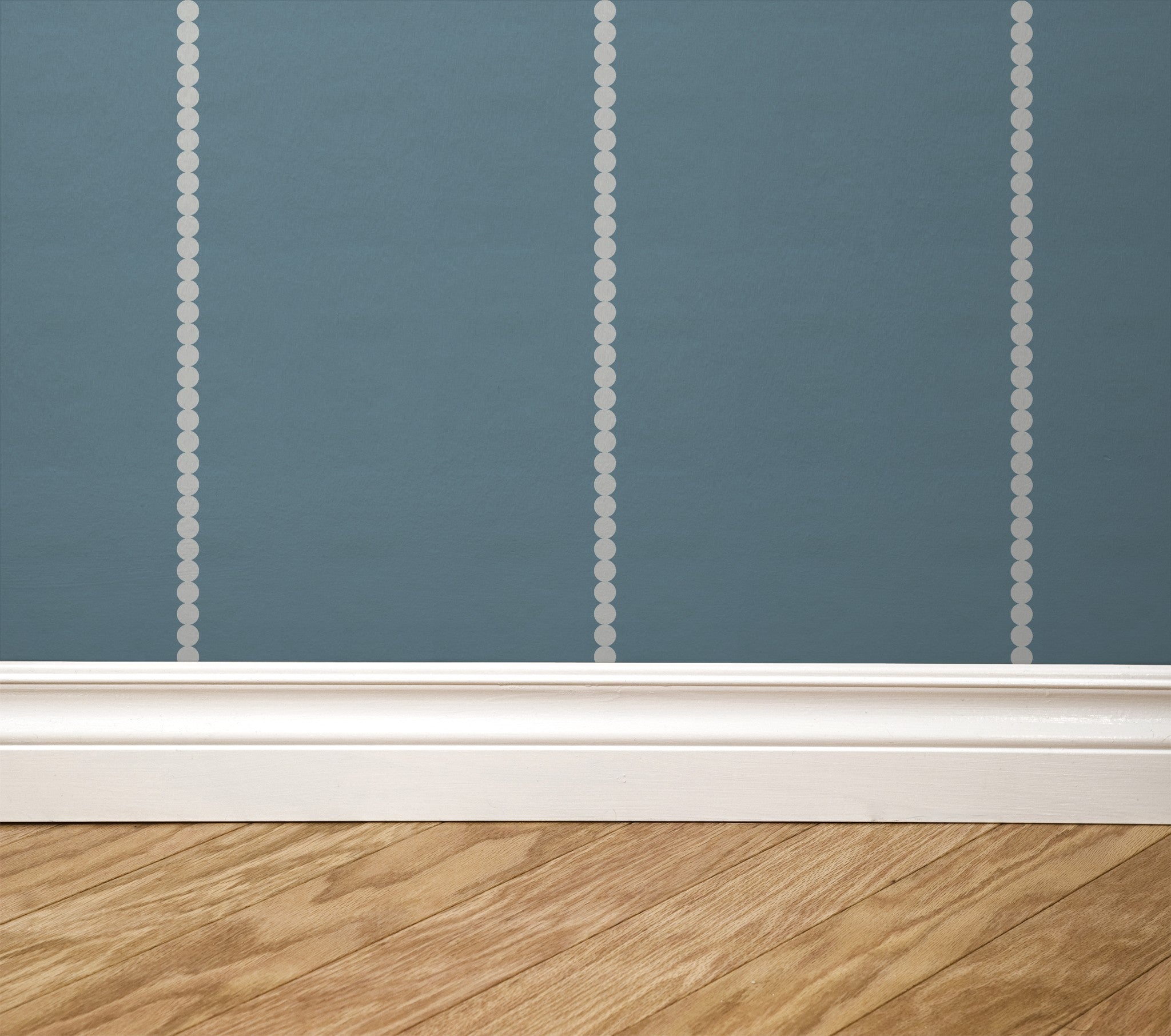 Blue pinstripe dot wallpaper with white baseboard and wood floor
