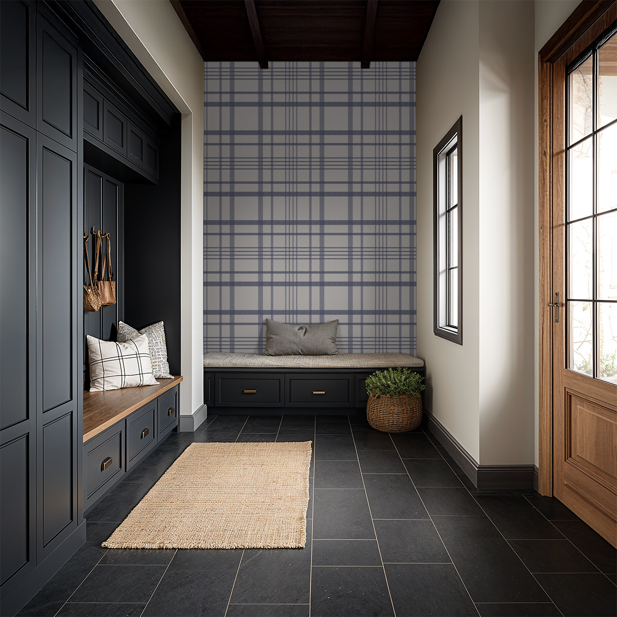 Blue plaid wallpaper in modern entryway with bench and black cabinets.