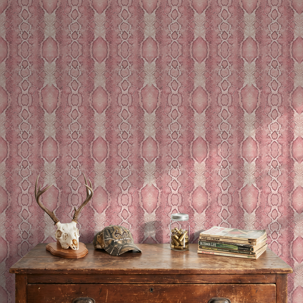 Blush Burmese wallpaper with pink snake pattern in rustic room setting.