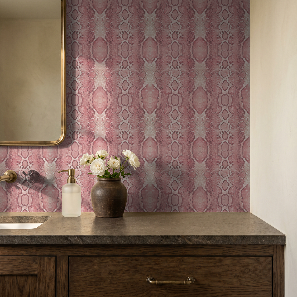 Blush Burmese snake pattern wallpaper in elegant bathroom setting with mirror and flowers.