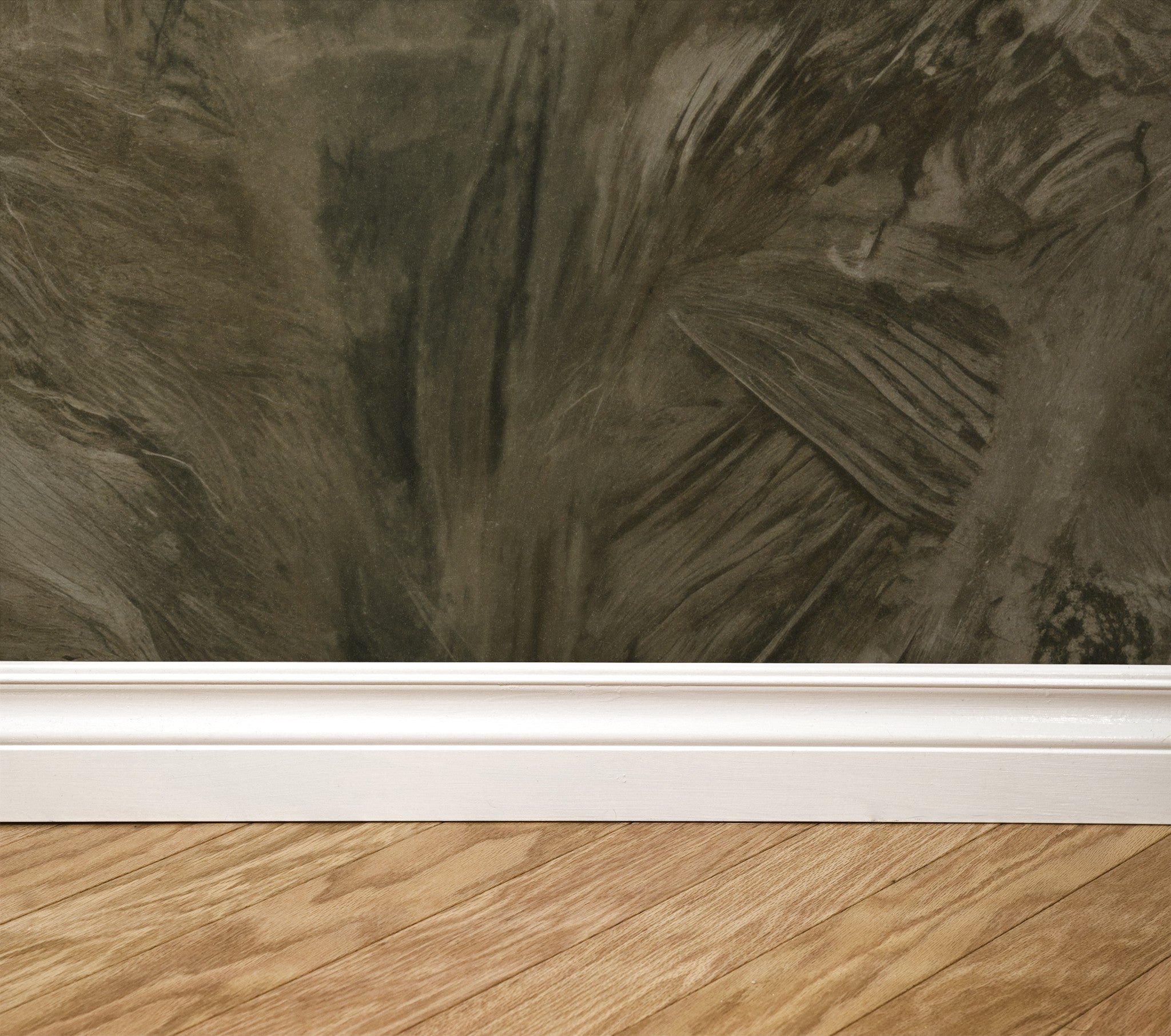 Earthy brown textured wallpaper with brushstroke pattern above white baseboard and wood floor.