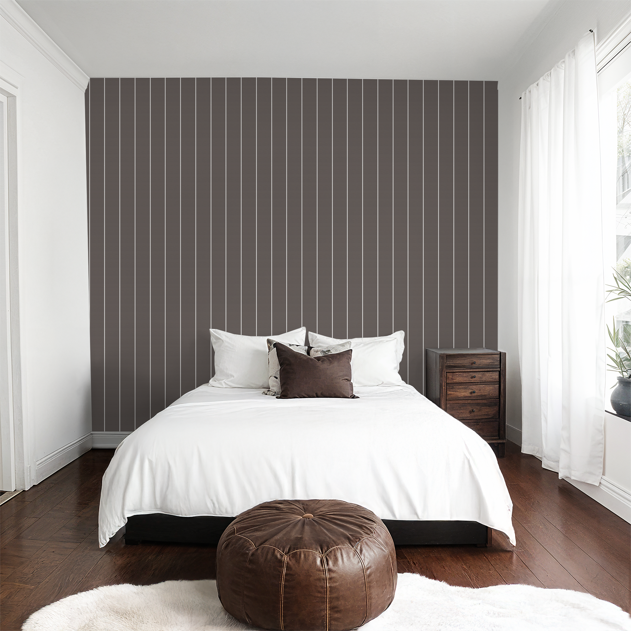 Brown pinstripe dot wallpaper in modern bedroom with white bedding and wooden furniture.