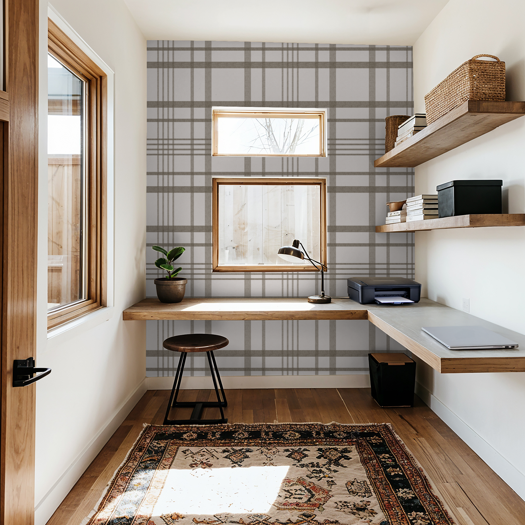 Brown plaid wallpaper in modern home office with wooden desk and shelves.