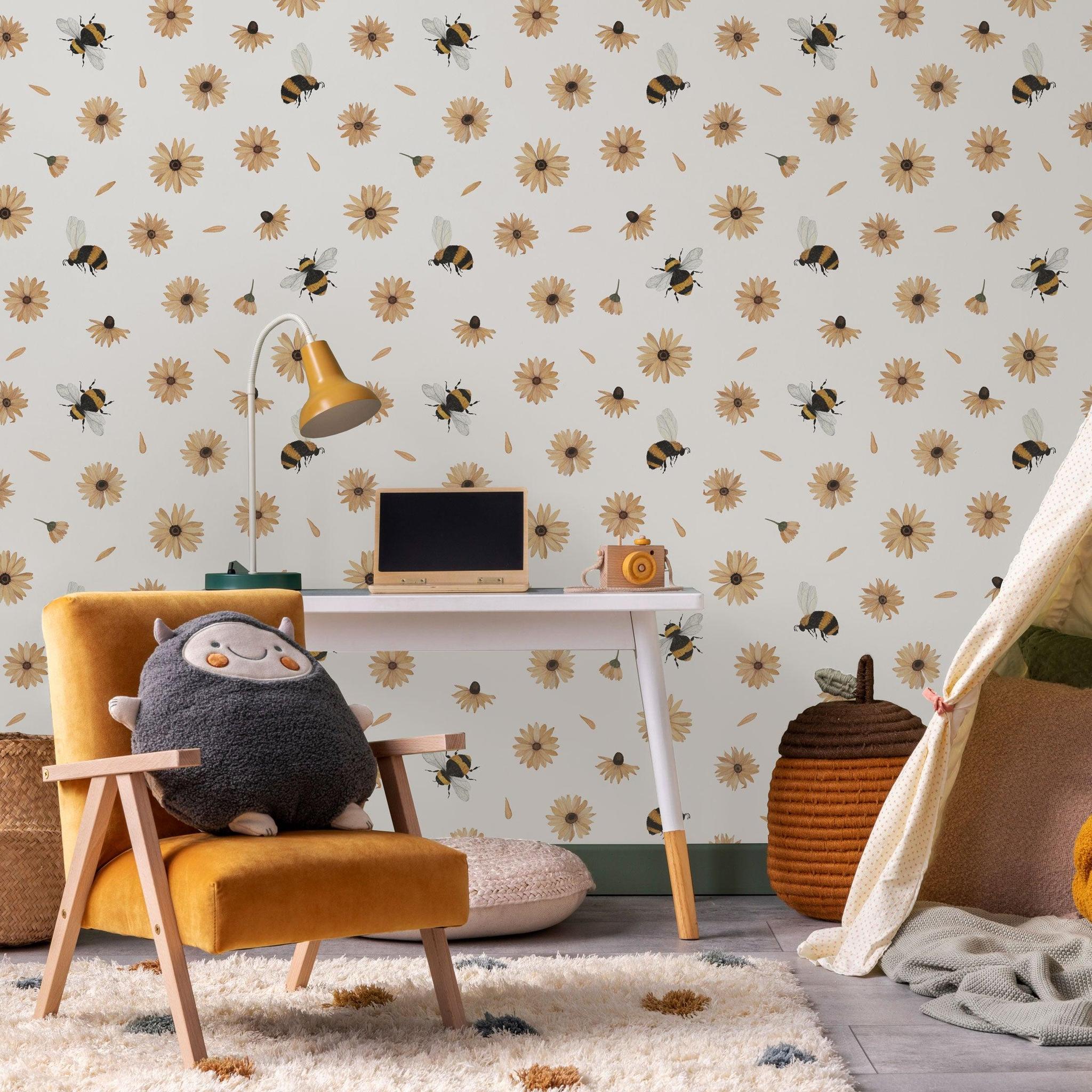 Bumble (White) Wallpaper by Wall Blush in cozy child's room setup, featuring playful bee and daisy design.
