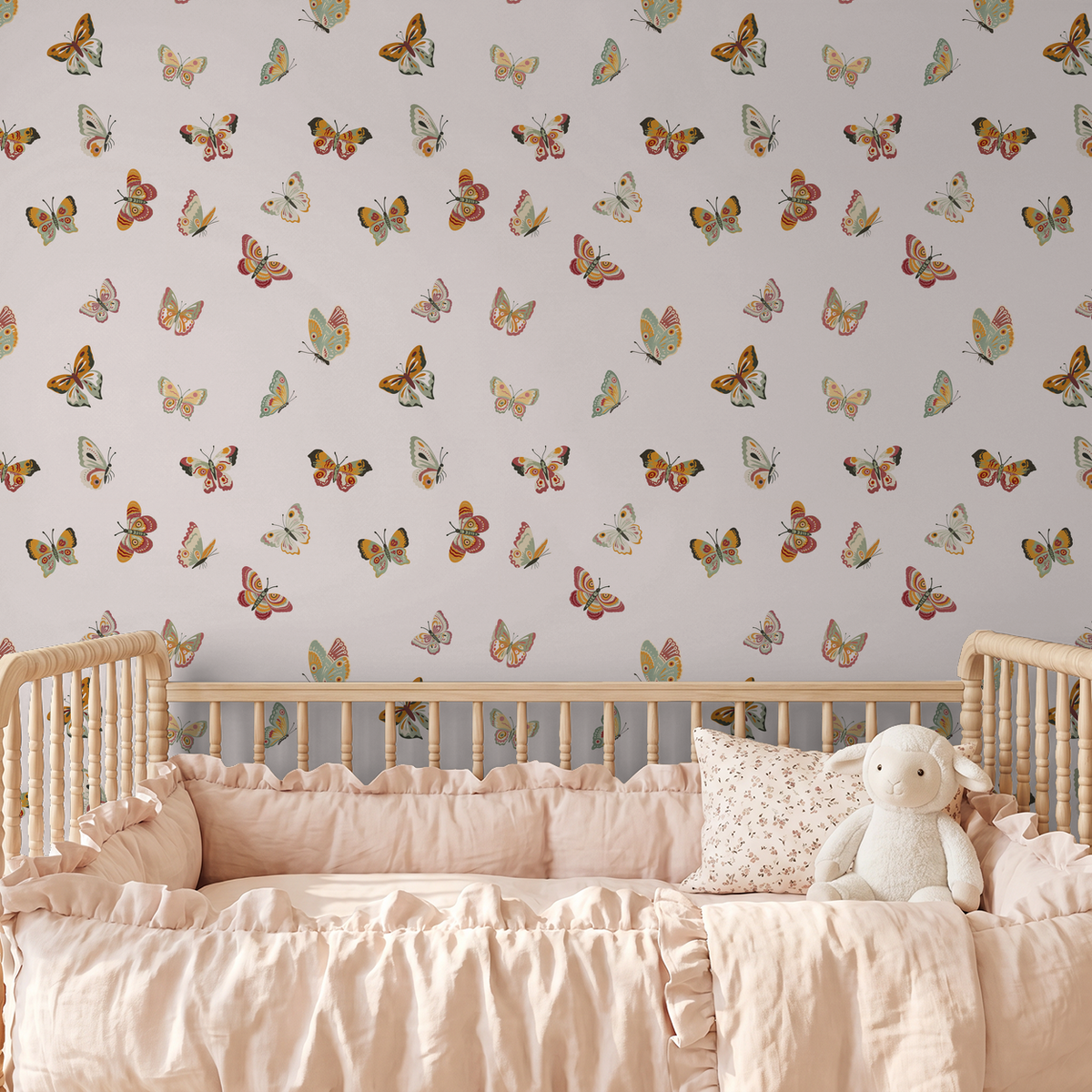 Butterfly patterned wallpaper in soft cream with colorful butterflies in a nursery setting.