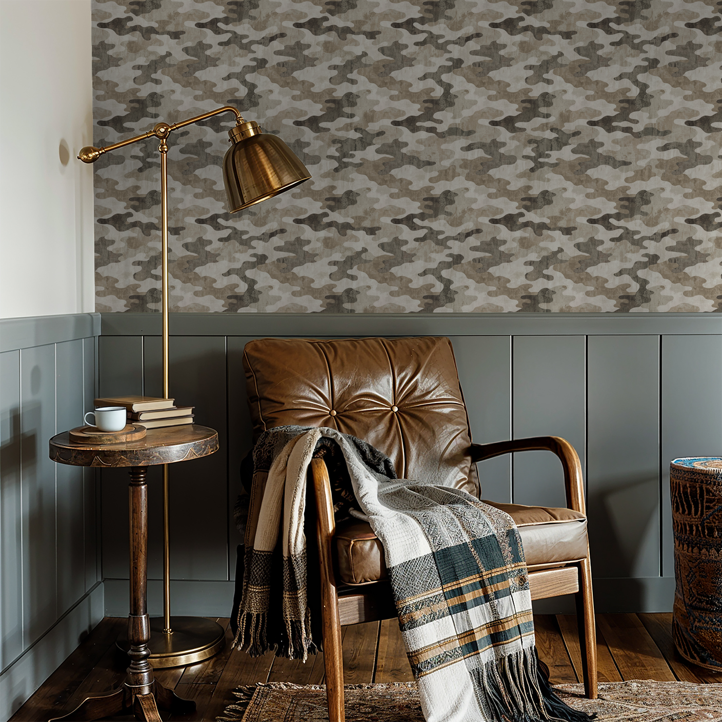 Camouflage wallpaper in earth tones with leather chair and brass lamp in cozy nook.