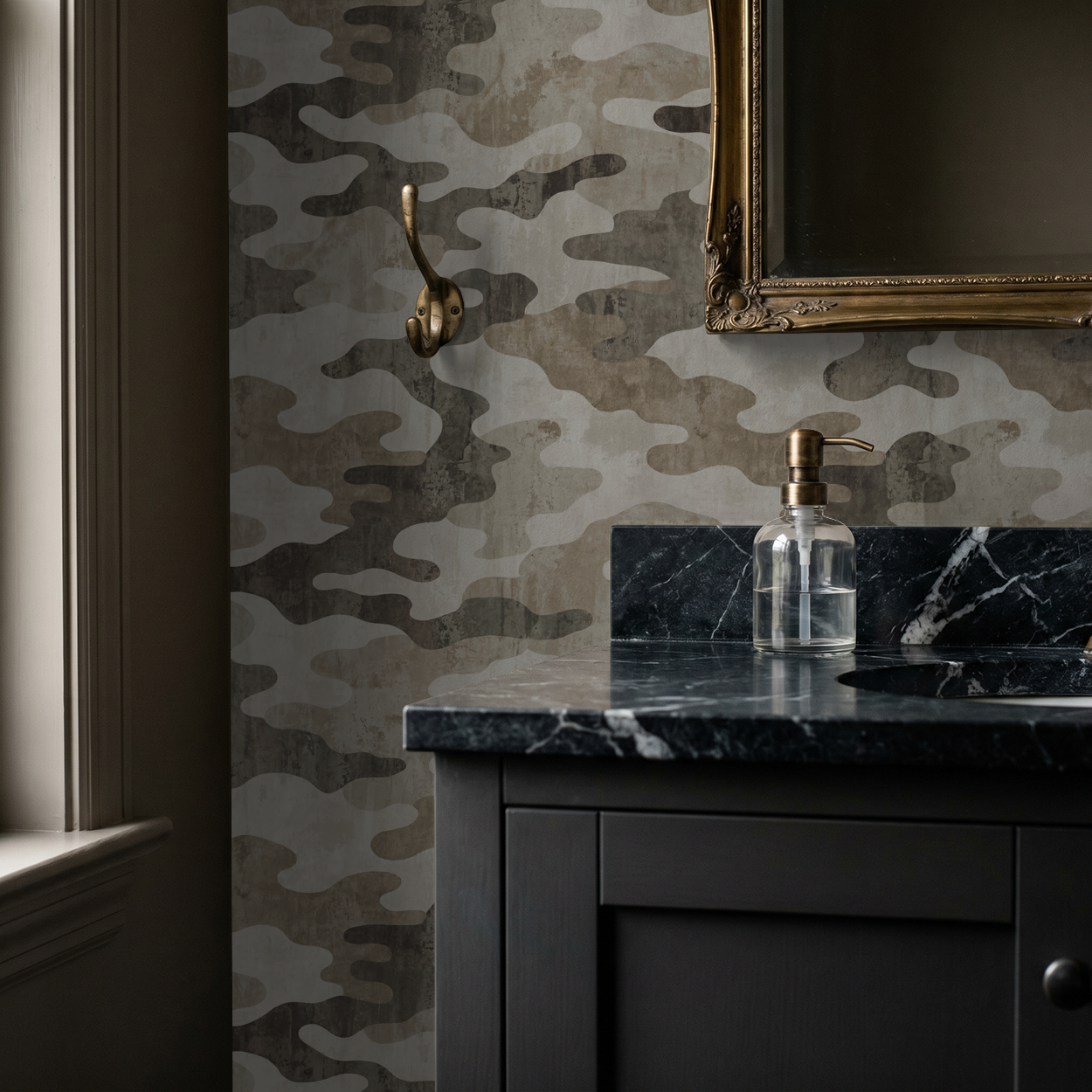 Camouflage pattern wallpaper in earthy tones in a bathroom with dark vanity and gold mirror.