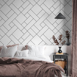 "Modern bedroom featuring Wall Blush Check Mate Wallpaper, geometric design focus, cozy bedding accents."