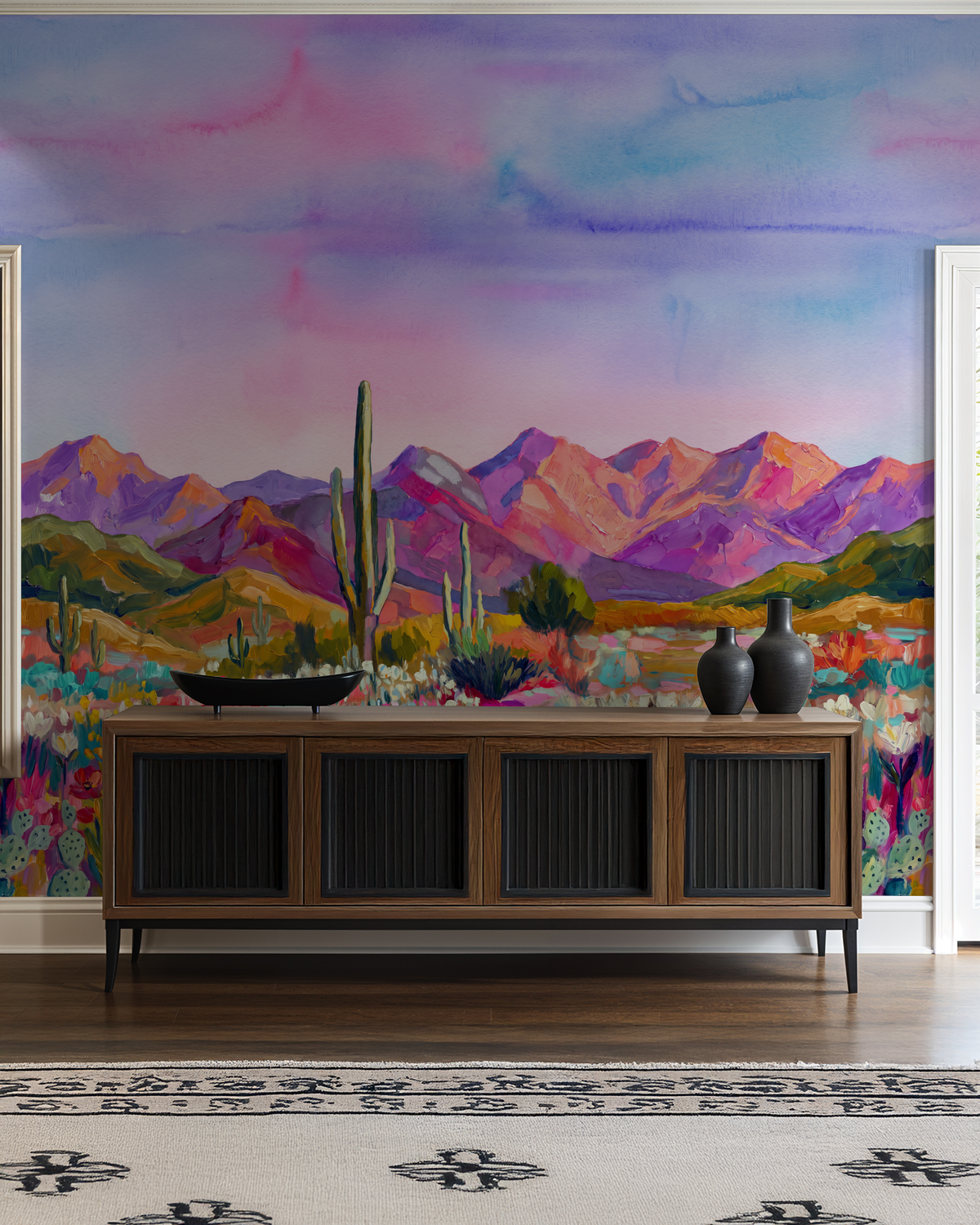 Colorful desert landscape wallpaper with mountains and cacti in a modern living room.