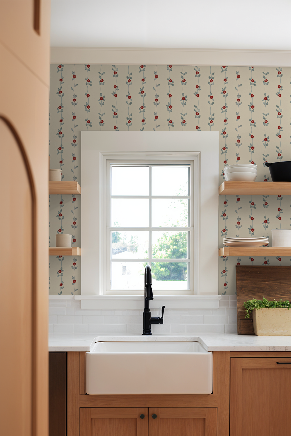 Cream wallpaper with red floral vine pattern in a kitchen setting