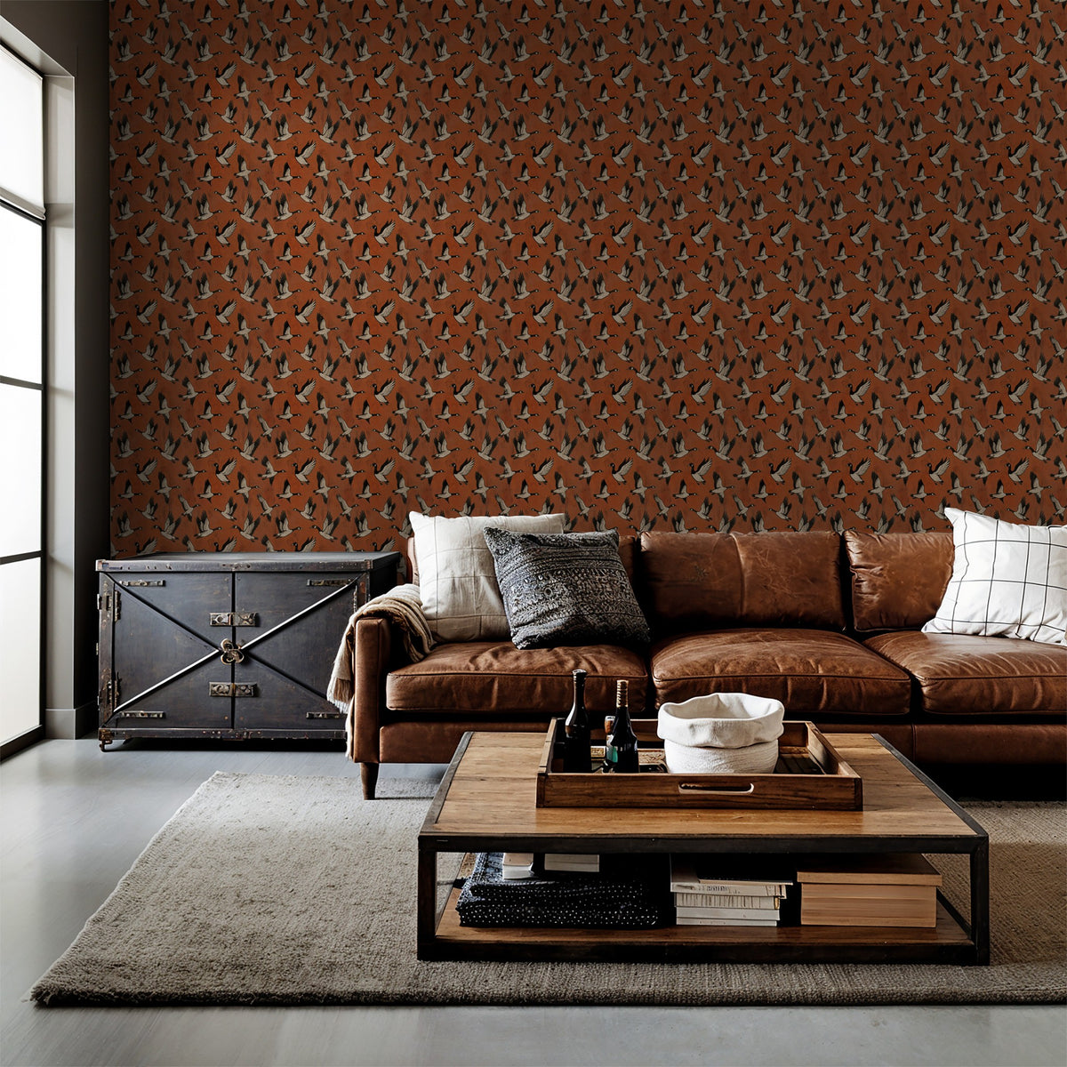 Crimson goose pattern wallpaper in rustic living room with leather sofa.