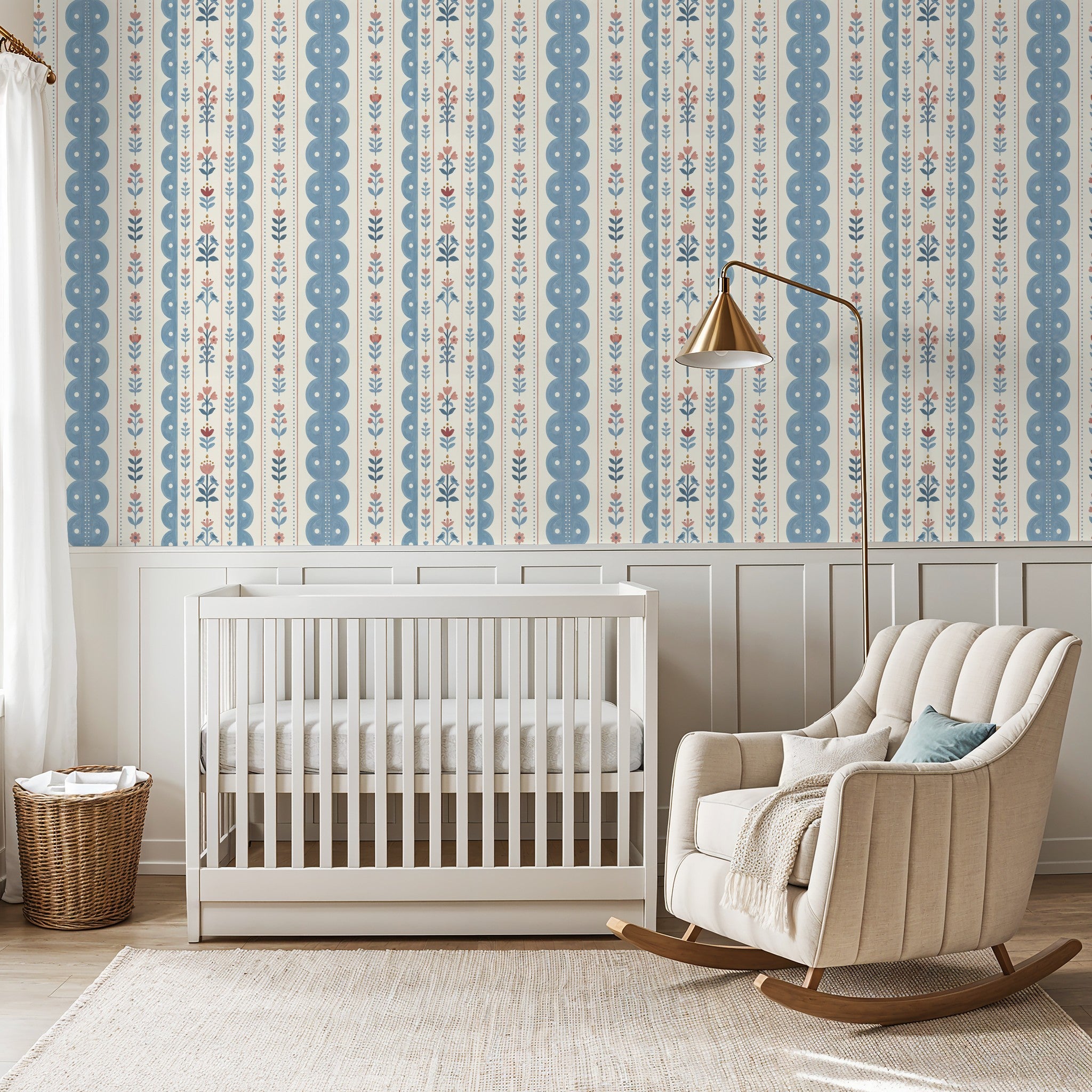 Dahlia Dreams wallpaper with blue and coral floral stripes in a cozy nursery setting.
