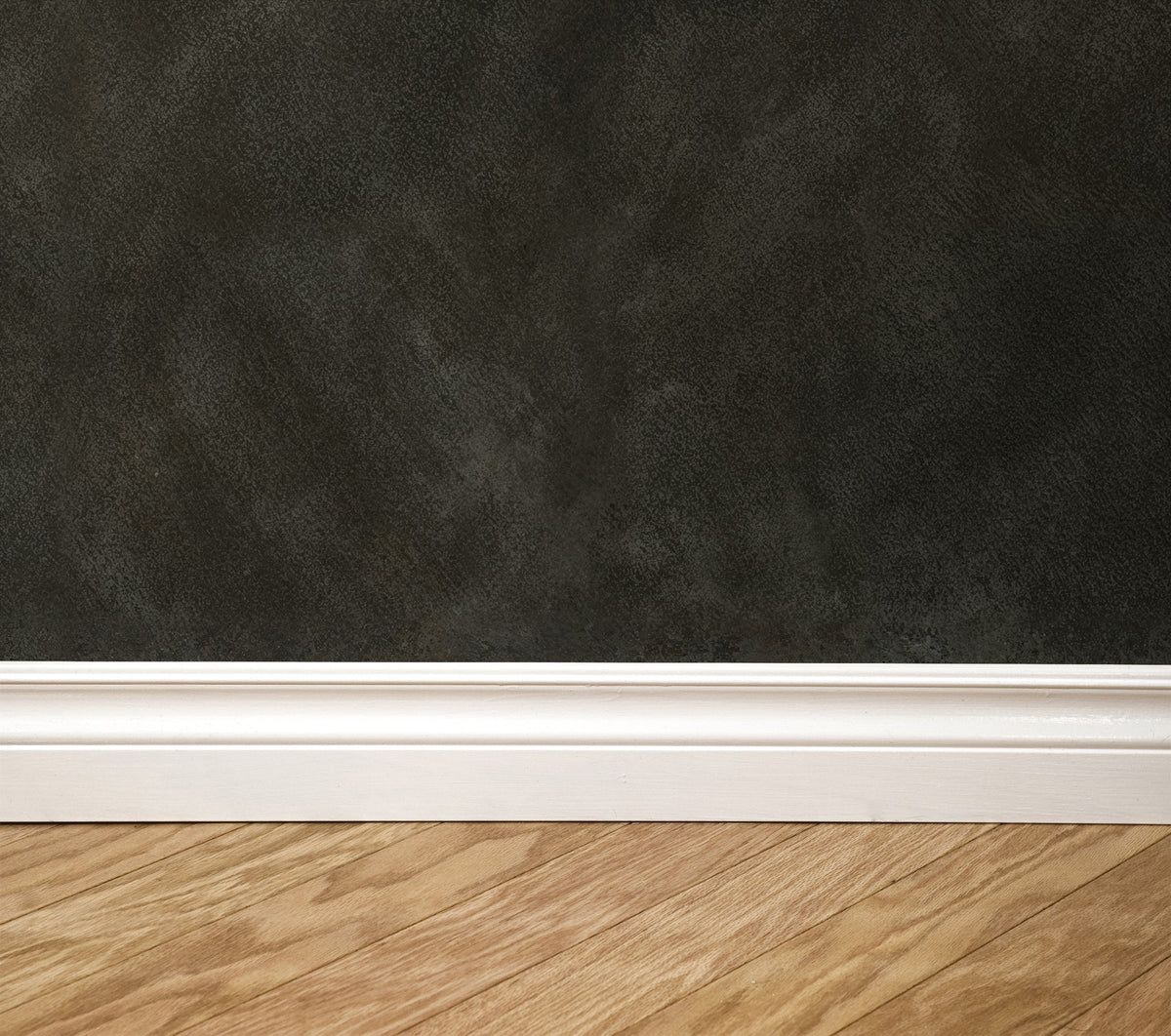 Dark textured wallpaper with white baseboard and wooden floor